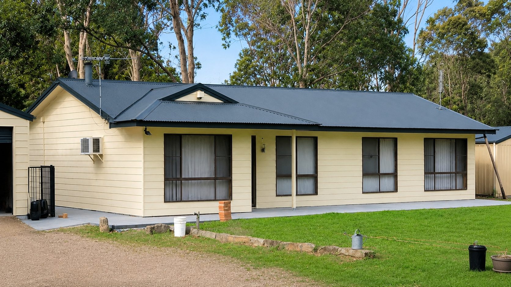 Weatherboard home with a freshly painted dark Colorbond roof